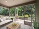 Screened in patio with an outdoor seating area and scenic backyard view, perfect for relaxing and entertaining at 12421 Angel Vale Pl, Durham, NC 27703