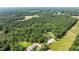 Estate home features large lawn and surrounding trees from an aerial perspective at 125 Attena Way, Zebulon, NC 27597