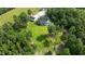 Aerial view of home nestled in trees with large lawn at 125 Attena Way, Zebulon, NC 27597