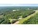 The house in natural wooded surroundings features a sprawling lawn at 125 Attena Way, Zebulon, NC 27597