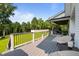 Spacious deck with outdoor seating area and railing overlooking the lush green yard and mature trees at 125 Attena Way, Zebulon, NC 27597