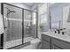 Well-lit bathroom featuring a glass-enclosed shower with modern fixtures and a stylish vanity with a marble top at 125 Attena Way, Zebulon, NC 27597