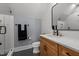 Well-lit bathroom with a modern vanity, sleek fixtures, and a glass-enclosed shower for a spa-like retreat at 125 Attena Way, Zebulon, NC 27597