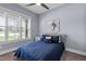 Comfortable bedroom with a plush bed, neutral decor, large window, and a ceiling fan for comfort at 125 Attena Way, Zebulon, NC 27597