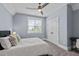 Inviting bedroom featuring neutral tones, a plush bed, soft lighting, and a ceiling fan for added comfort at 125 Attena Way, Zebulon, NC 27597