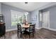 A bright dining room is illuminated by natural light and features stylish light fixtures at 125 Attena Way, Zebulon, NC 27597
