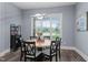 Well-lit dining area with a round table, comfortable seating, and large window view at 125 Attena Way, Zebulon, NC 27597