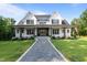 Charming two-story home boasting a gray stamped concrete walkway and lush green lawn at 125 Attena Way, Zebulon, NC 27597