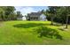 Beautiful home showcasing the landscaped lawn and covered porch at 125 Attena Way, Zebulon, NC 27597