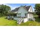 Rear exterior of a beautiful home with a spacious yard, deck, and patio for outdoor living at 125 Attena Way, Zebulon, NC 27597