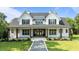Stunning two-story home with a welcoming front porch and beautifully landscaped front yard at 125 Attena Way, Zebulon, NC 27597