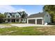 Newly constructed farmhouse with a detached garage and concrete driveway at 125 Attena Way, Zebulon, NC 27597