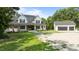 New home features a well-maintained lawn and detached two-car garage at 125 Attena Way, Zebulon, NC 27597