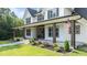 Side view of a lovely two-story home featuring a welcoming porch with sturdy support pillars at 125 Attena Way, Zebulon, NC 27597