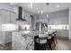 Modern kitchen boasts a large granite island with seating and stainless steel appliances at 125 Attena Way, Zebulon, NC 27597