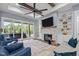Living room featuring a stone fireplace, sliding glass doors, and high, beamed ceilings at 125 Attena Way, Zebulon, NC 27597