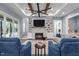 Living room features a stone fireplace, tray ceilings and plenty of seating at 125 Attena Way, Zebulon, NC 27597
