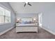 Spacious main bedroom featuring a ceiling fan, neutral walls, carpeted floor, and abundant natural light at 125 Attena Way, Zebulon, NC 27597