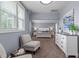 Bright main bedroom with white trim, neutral gray walls, carpeted floor, and modern decor create a soothing atmosphere at 125 Attena Way, Zebulon, NC 27597