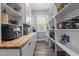 Walk-in pantry features built-in shelving providing ample storage space for kitchen supplies at 125 Attena Way, Zebulon, NC 27597