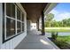 Extended porch featuring stained wood beam ceiling and stone support pillars at 125 Attena Way, Zebulon, NC 27597