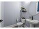A half-bath features a pedestal sink and modern fixtures with elegant decorations at 125 Attena Way, Zebulon, NC 27597
