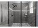 Modern tiled shower with a glass enclosure and sleek fixtures creating a spa-like experience at 125 Attena Way, Zebulon, NC 27597