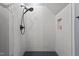 Modern shower with elegant white tiles, a rain shower head, and a unique design for a luxurious experience at 125 Attena Way, Zebulon, NC 27597