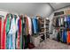 Organized walk-in closet featuring ample hanging space, shelving, baskets, and neutral carpet flooring at 125 Attena Way, Zebulon, NC 27597