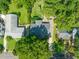 A bird's eye view shows the home's placement on a tree-lined street, with a long driveway and detached garage at 1311 Norton St, Durham, NC 27701