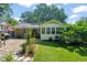 Backyard patio with stone pavers, flower beds, and well-maintained lawn at 1311 Norton St, Durham, NC 27701