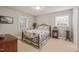 Sunlit bedroom featuring floral bedding, natural light from two windows and wooden accents at 1311 Norton St, Durham, NC 27701