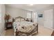 Bedroom features a floral bedspread, a small window, and ensuite bathroom at 1311 Norton St, Durham, NC 27701