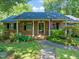 Charming brick home featuring a manicured front yard and inviting front porch with an American flag at 1311 Norton St, Durham, NC 27701