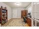 Functional home office with a desk, bookshelf, decorative screen, and natural light at 1311 Norton St, Durham, NC 27701
