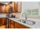 Bright kitchen featuring stainless steel sink, granite countertops, stainless steel appliances and wooden cabinets at 1311 Norton St, Durham, NC 27701
