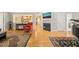 Bright living room featuring hardwood floors, a fireplace, and an open view to the kitchen at 1311 Norton St, Durham, NC 27701