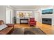 Open living room showcasing hardwood floors, a fireplace, and views of the adjacent kitchen at 1311 Norton St, Durham, NC 27701