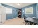 This home office features blue walls, neutral carpet, and great natural light at 1311 Norton St, Durham, NC 27701