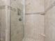 Tiled shower features a built-in shelf and decorative tile accents at 1311 Norton St, Durham, NC 27701