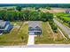 Beautiful aerial view of the home, showcasing landscaping and pond views at 1321 White Spruce Dr, Willow Springs, NC 27592
