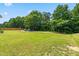 Wide open backyard featuring a large lawn and private patio with outdoor seating at 1321 White Spruce Dr, Willow Springs, NC 27592