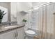 Well-lit bathroom with a granite countertop vanity and shower-tub combination at 1321 White Spruce Dr, Willow Springs, NC 27592