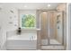 Beautiful bathroom featuring a separate shower and a soaking tub by the window at 1321 White Spruce Dr, Willow Springs, NC 27592