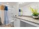 Well-lit bathroom featuring a shower-tub combination and granite countertop vanity at 1321 White Spruce Dr, Willow Springs, NC 27592