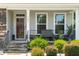 Inviting front porch area with seating and decorative landscaping at 1321 White Spruce Dr, Willow Springs, NC 27592