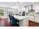Open kitchen with island seating, pendant lighting, stainless steel appliances, and view of dining area at 1321 White Spruce Dr, Willow Springs, NC 27592