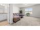 Bright living room with natural light, neutral carpet, and comfortable sectional couch at 1321 White Spruce Dr, Willow Springs, NC 27592