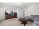Spacious living room features neutral carpet, furniture, and TV; perfect for relaxing at 1321 White Spruce Dr, Willow Springs, NC 27592