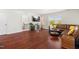 Cozy living room with hardwood flooring, brown leather couch, and mounted television at 1321 White Spruce Dr, Willow Springs, NC 27592